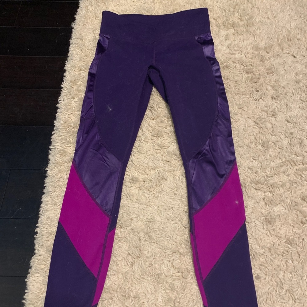 Purple leggings with leather on them